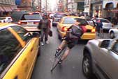 Photo of fast bikes veering between slow cars in New York City